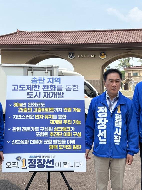 더불어민주당 정장선 평택시장 후보가 송탄 K-55 미군 비행장 앞에서 송탄지역 고도완화 등 북부지역 관련 공약을 발표하고 있다.