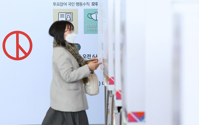 한 시민이 투표용지를 들고 기표소로 들어가고 있다. 연합뉴스