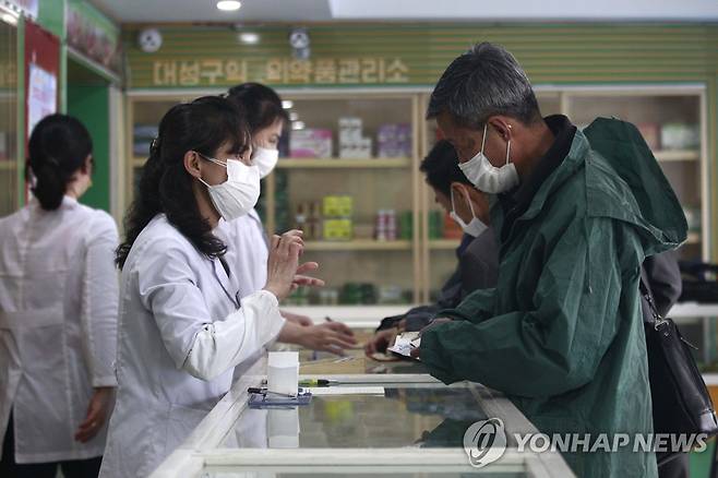 코로나 확산 속 약품 처방하는 평양 약국 직원들 (평양 AP=연합뉴스) 북한 평양의 대성구에서 16일 의약품관리소(약국) 직원들이 주민들에게 약을 처방해주고 있다. 조선중앙통신에 따르면 최근 북한에서 코로나19가 급속하게 확산하는 가운데 이날 신규 발열자는 26만9천여 명, 사망자는 6명이 발생한 것으로 집계됐다. 2022.5.17 sungok@yna.co.kr