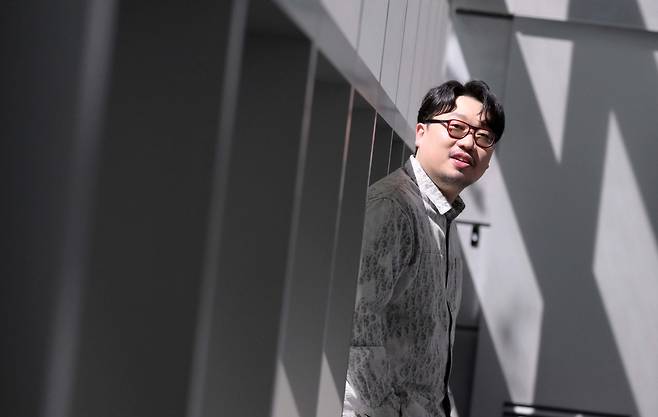 Big Hit Music producer Pdogg poses for photos during an interview with The Korea Herald at Hybe’s headquarters in Yongsan-gu, Seoul, on Tuesday. (Lee Sang-sub/The Korea Herald)