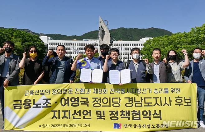 [창원=뉴시스] 홍정명 기자= 여영국(왼쪽) 정의당 경남도지사 후보가 26일 경남도청 정문 앞에서 박홍배 전국금융산업노동조합 위원장과 정책협약을 체결한 후 관계자들과 기념촬영을 하고 있다.(사진=여영국 후보 선거사무소 제공) 2022.05.26. photo@newsis.com