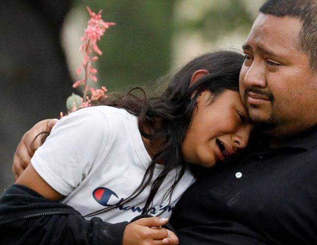 미국 텍사스주 유밸디의 롭초등학교 인근 시민회관 밖에서 지난 24일(현지시간)  한 아이가 가족의 품에 안겨 눈물을 흘리고 있다. 이 학교에서 발생한 무차별 총기 난사로 학생 19명과 교사 2명 등 21명이 숨졌다. 로이터연합뉴스