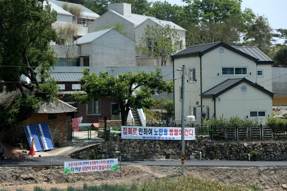 25일 경남 양산시 하북면 지산리 평산마을 문재인 전 대통령 사저 앞에 문 전 대통령 반대단체 집회, 1인 시위에 항의하는 마을주민 현수막이 내걸려 있다. 2022.5.25 연합뉴스