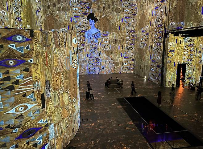 클림트가 유화 물감과 금을 섞어 그린 ‘아델레 블로흐–바우어의 초상’이 전시장 전체를 순도 높은 금빛으로 물들이고 있다. 최고 높이 21m의 수직성이 관람객의 감각을 압도한다. /정상혁 기자