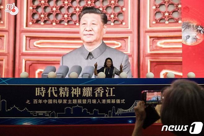 8일(현지시간) 홍콩 컨벤션센터에서 열린 중국 공산당 창당 100주년을 기념하는 전시회서 방문객이 시진핑 국가 주석의 스크린 앞에서 포즈를 취하고 있다. © AFP=뉴스1 © News1 우동명 기자