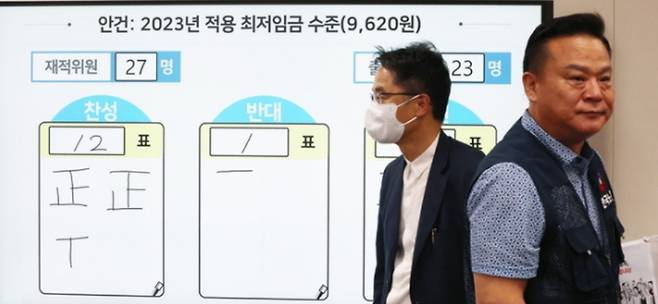 최저임금위원회가 지난 29일 밤 정부세종청사에서 8차 전원회의를 열고 내년도 최저임금을 시간당 9620원으로 결정한 직후 모습. 박준식 위원장(왼쪽)과 노동자위원인 이동호 한국노총 사무총장이 인사한 뒤 돌아서고 있다. 연합뉴스