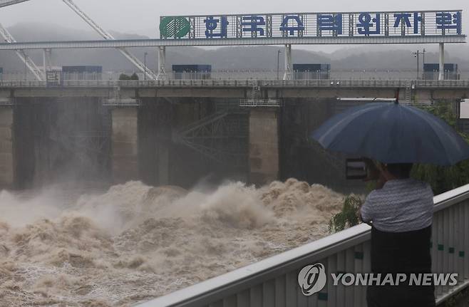 통일부 "北 사전통지 없이 황강댐 방류에 유감" (하남=연합뉴스) 신준희 기자 = 30일 하남시 팔당댐 근처에서 한 시민이 집중호우로 방류 중인 댐을 보고 있다. 2022.6.30 hama@yna.co.kr