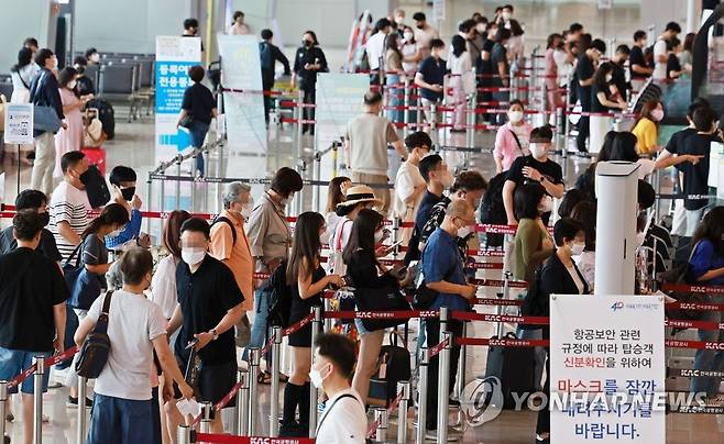 코로나19 확산세 속 붐비는 공항 (서울=연합뉴스) 한종찬 기자 = 코로나19 확산세가 거세지는 가운데 15일 오전 서울 강서구 김포공항 국내선 청사에서 이용객들이 탑승 수속을 밟고 있다. 2022.7.15 saba@yna.co.kr