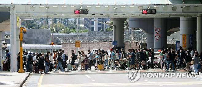 제주공항에 도착한 관광객들이 캐리어를 끌고 렌터카 주차장으로 향하고 있는 모습 [연합뉴스 자료사진]