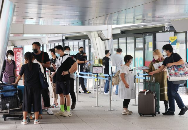 코로나19 해외유입 역대 최다를 기록한 27일 오후 인천국제공항 제1여객터미널 입국자 전용 코로나 검사센터 앞이 검사를 받거나 마친 해외 입국자들로 붐비고 있다. 연합뉴스