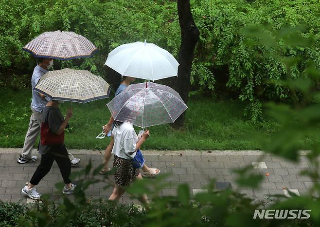 [서울=뉴시스] 김금보 기자 = 전국 대부분 지역에 비가 내린 지난달 31일 오후 서울 서초구 양재천길에서 우산을 쓴 시민들이 녹음 속을 산책하고 있다. 2022.07.31. kgb@newsis.com