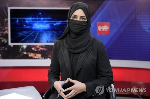 탈레반의 지시에 따라 마스크를 쓰고 진행에 나선 아프간 톨로뉴스 여성 앵커 [AP 연합뉴스 자료사진. 재판매 및 DB 금지]