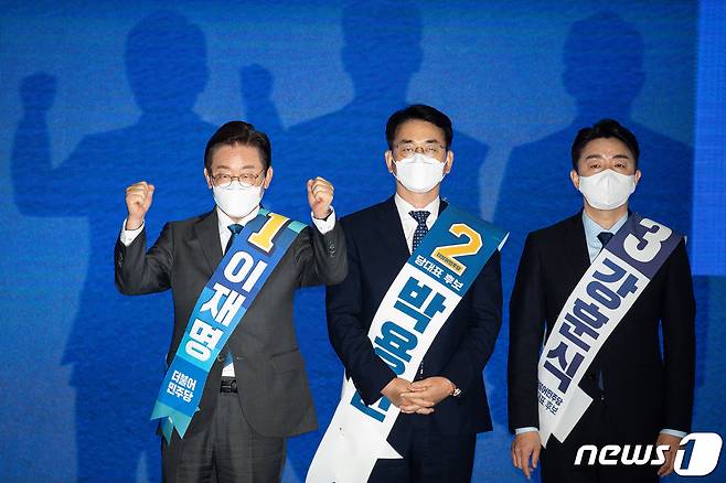 이재명 더불어민주당 당대표 후보(왼쪽)가 6일 대구 엑스코에서 열린 민주당 당대표 및 최고위원 후보자 대구·경북지역 합동연설회 후 강원, 대구·경북 권리당원 투표 결과 발표에서 74.81% 득표가 발표되자 주먹을 불끈 쥐고 있다. 왼쪽부터 이재명, 박용진, 강훈식 후보. 민주당 중앙선거관리위원회는 이날 강원, 대구·경북 권리당원 투표 결과, 이재명 후보가 74.81%, 박용진 후보 20.31%, 강훈식 후보 4.88%의 득표율을 기록했다고 밝혔다. 2022.8.6/뉴스1 ⓒ News1 유승관 기자