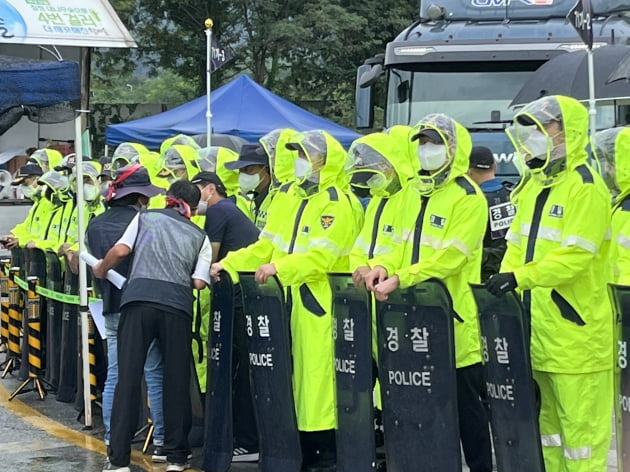 8일 강원도 홍천군 강원공장 진입로에서 경찰이 시위대를 마주하고 화물차 출차로를 확보하고 있다. 사진=한경제 기자