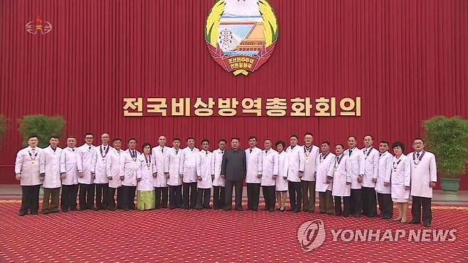 북한 김정은, 방역 및 보건부문 관계자들과 기념사진 (서울=연합뉴스) 북한 전국비상방역총화회의가 지난 10일 평양에서 진행됐다고 조선중앙TV가 11일 보도했다. 회의에서 김정은 국무위원장은 신종 코로나바이러스 감염증(코로나19) 위기가 완전히 해소됐다고 선언했다. 이날 김 위원장은 방역 및 보건부문 관계자들을 격려하고 기념사진을 찍었다. [조선중앙TV 화면] 2022.8.11 
    [국내에서만 사용가능. 재배포 금지. For Use Only in the Republic of Korea. No Redistribution] nkphoto@yna.co.kr