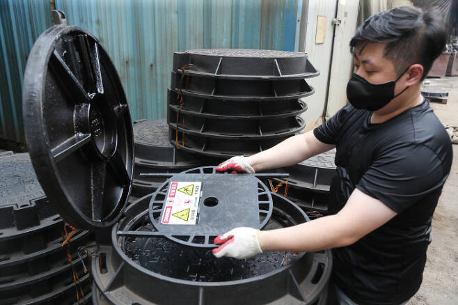 부산 사상구에 있는 한 업체 직원이 12일 추락방지시설이 설치된 맨홀 제품을 설명하고 있다. 연합뉴스