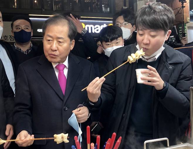 홍준표 국민의힘 의원과 이준석 당 대표가 지난 2월 12일 오후 대구 동성로 어묵가게에서 어묵을 먹고 있는 모습. /뉴스1