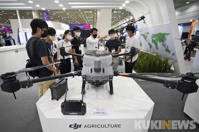 18일 오후 서울 강남구 코엑스에서 열린 '2022 무인이동체산업엑스포'를 찾은 관람객들이 농업용 드론 등을 살펴보고 있다.