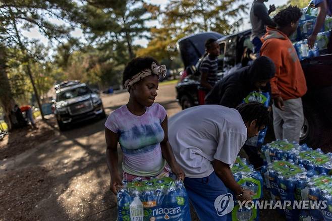 수돗물 끊긴 미국 잭슨시 (잭슨[美미시시피주] 로이터=연합뉴스] 지난 2일(현지시간) 미국 미시시피주 잭슨시에서 자원봉사자들이 사람들에게 나눠줄 생수를 운반하고 있다. 2022.9.5 photo@yna.co.kr