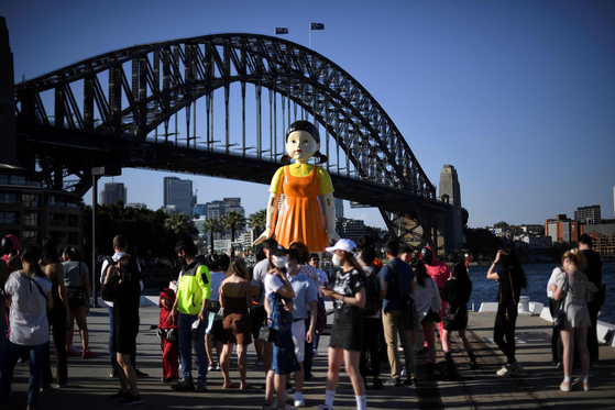 A replica doll of Young-hee, a large motion-sensing animatronic doll from “Squid Game,” was installed between the Opera House and Harbour Bridge in Sydney from Oct. 29 to Nov. 1. [YONHAP]