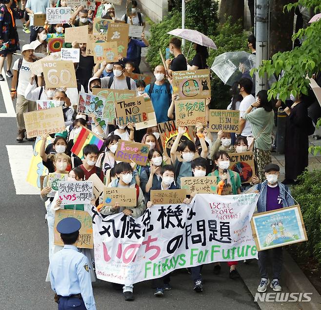 [도쿄=AP/뉴시스] 일본 도쿄 시내에서 23일 환경운동가들이 지구온난화에 반대하는 시위를 펼치고 있다. 2022.09.23