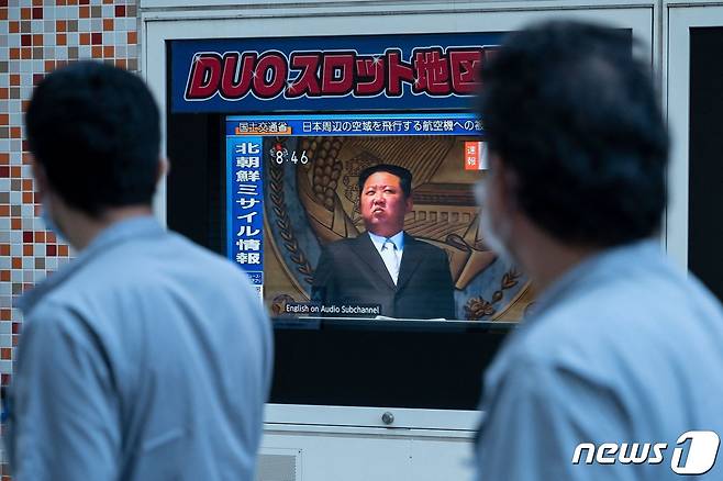 4일오전 일본 도쿄에서 시민들이 북한의 중거리탄도미사일 발사 관련 보도를 시청하며 길을 걷고 있다. 2022.10.04/뉴스1 ⓒ AFP=뉴스1
