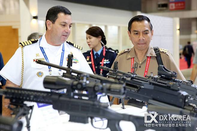 방산 전시회를 방문한 외국군 장교들이 국산 총기들을 살펴보고 있다.