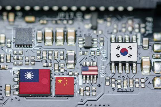 Flags of Korea, the U.S., Taiwan and China are shown on a printed circuit board. High-tech products like semiconductors are a focus for the United States as it seeks to protect its economy from China by shifting the manufacturing of these products to the home market. Companies in Korea are finding that their dependence on China for high-tech manufacturing and materials has become a liability.
