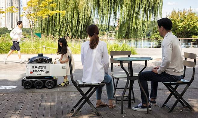 배달의민족을 운영하는 우아한형제들의 배달로봇 ‘딜리드라이브’가 경기 수원시 광교호수공원에서 음료를 배달하고 있다. 우아한형제들 제공