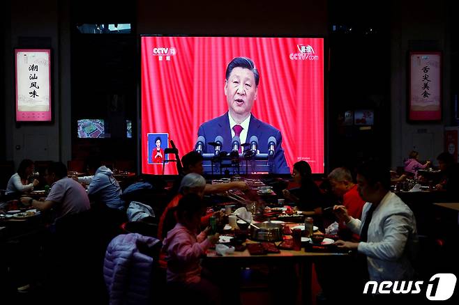 16일(현지시간) 중국 베이징의 한 식당 안에서 사람들이 시진핑 주석의 중국 공산당 제20차 전국대표대회(당대회) 개막식 연설 생중계 화면 앞에서 식사를 하고 있다. ⓒ 로이터=뉴스1 ⓒ News1 한병찬 기자