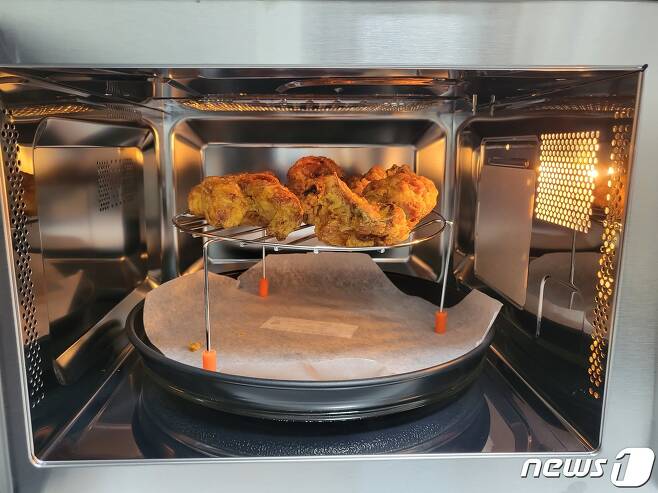 28일 취재진이 SK매직 멀티 플렉스 광파오븐에 냉동 치킨을 넣고 있다.ⓒNews1 신윤하 기자.