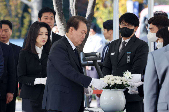 윤석열 대통령과 김건희 여사가 31일 오전 서울광장에 마련된 이태원 사고 사망자 합동분향소를 방문, 헌화를 위해 국화꽃을 건네 받고 있다. 연합뉴스