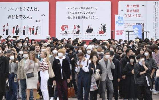 핼러윈을 이틀 앞둔 지난 29일 도쿄 시부야 거리를 사람들이 걸어가고 있다. 인파 뒤쪽으로 28일부터 내달 1일까지 노상 음주 금지 기간이라는 안내문 등이 보인다. 연합뉴스