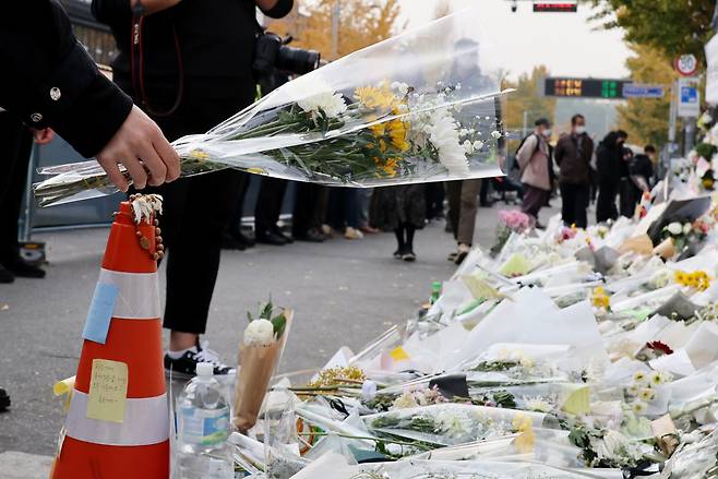 Flowers are laid for the victims of the Halloween crowd crush outside the Itaewon subway station on Wednesday. (Yonhap)