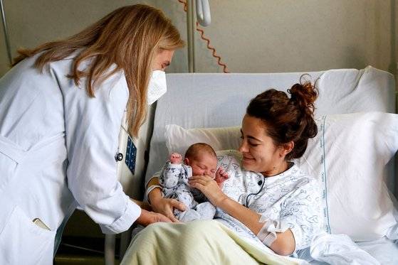 지난 14일 이탈리아 로마의 한 병원에서 산모가 출산 후 신생아를 안은채 의료진과 만나고 있다. 로이터=연합뉴스