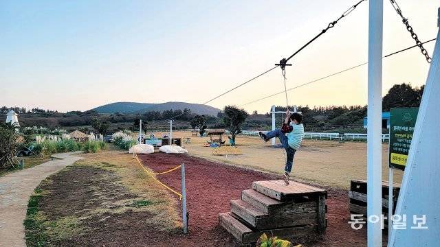 목장 카페 드르쿰다에서 짚라인을 체험하는 어린이.