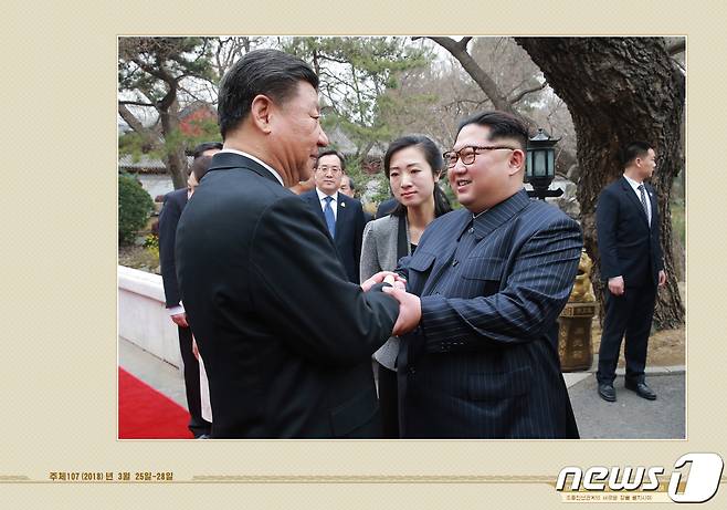 북한 외국문출판사가 12일 공개한 김정은 국무위원장 화보 '대외관계 발전의 새 시대를 펼치시어'. 김 위원장이 2018년 3월 중국을 방문해 시진핑 주석과 양원재에서 열린 오찬에 참석하며 악수하는 모습이 실려있다.(외국문출판사 화보 캡처) 2021.5.12/뉴스1