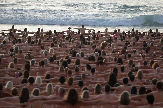 호주 시드니의 본다이 해변에서 옷을 벗은 2500명의 남녀가 어깨동무를 하고 있는 모습. /로이터 연합뉴스
