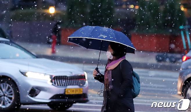 첫눈이 내린 지난해 11월 10일 오전 서울 시내에서 한 시민이 우산을 쓰고 발걸음을 옮기고 있다. 2021.11.10/뉴스1 ⓒ News1 박지혜 기자