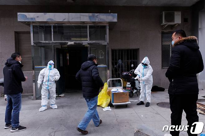 2일(현지시간) 중국 베이징에서 방역관들이 아파트에 들어가려는 사람들에게 방호복을 착용하도록 안내하고 있다. ⓒ 로이터=뉴스1 ⓒ News1 권진영 기자