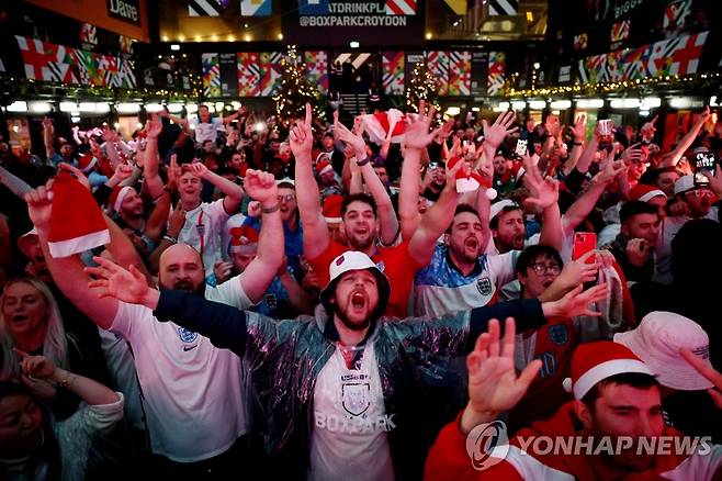 '8강 진출'에 환호하는 잉글랜드 축구 팬들 (런던 로이터=연합뉴스) 4일(현지시간) 영국 런던 남부 크로이든에 모인 축구 팬들이 2022 카타르 월드컵 16강 세네갈전에서 잉글랜드가 3-0으로 대승을 거두고 8강에 진출하자 환호하고 있다. 잉글랜드는 역사적으로 앙숙이었던 프랑스를 상대로 오는 10일 경기를 펼친다. 2022.12.05 alo95@yna.co.kr