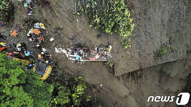 4일(현지시간) 콜롬비아 푸에블로 리코에서 산사태가 발생해 버스와 오토바이가 묻힌 현장서 구조대원이 실종자를 수색하고 있다. ⓒ AFP=뉴스1 ⓒ News1 우동명 기자