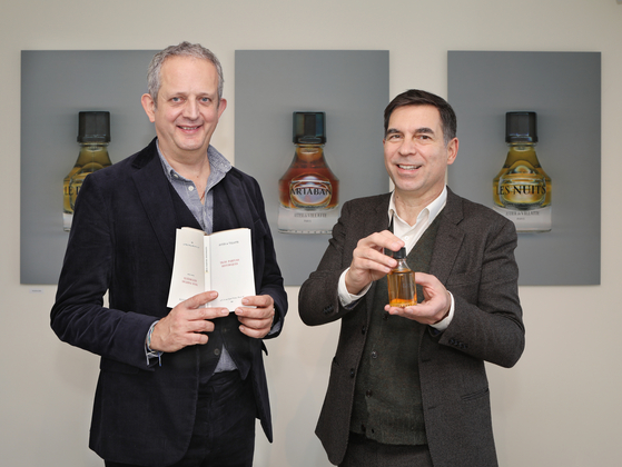 Ivan Pericoli, left, and Benoît Astier de Villatte, co-founders of French lifestyle brand Astier de Villatte with their new book and one of three perfumes Artaban, at the brand's flagship store in Seoul's Hannam-dong in central Seoul on Dec. 1. [PARK SANG-MOON]