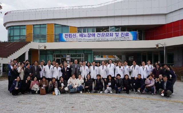 한국전립선-배뇨관리협회 김세철 회장을 비롯한 강남차병원 권성원 교수, 일산차병원 송재만 명예원장 등 무료진료 봉사단 100여 명이 기념촬영을 하고 있다.