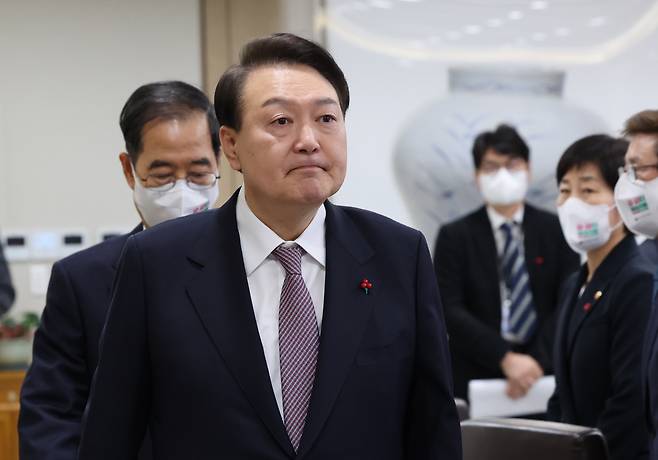 President Yoon Suk-yeol enters at a cabinet meeting held at the presidential office in Yongsan, Seoul on Dec. 13. (Yonhap)