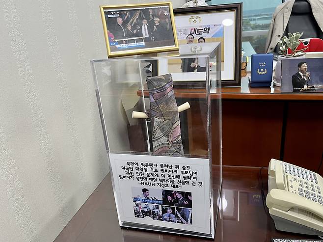 The necktie that belonged to Otto Warmbier, gifted to Ji by the late US student’s parents, hangs at the lawmaker’s office. Ji said he keeps it there as a reminder of what he has to do. (Kim Arin/The Korea Herald)