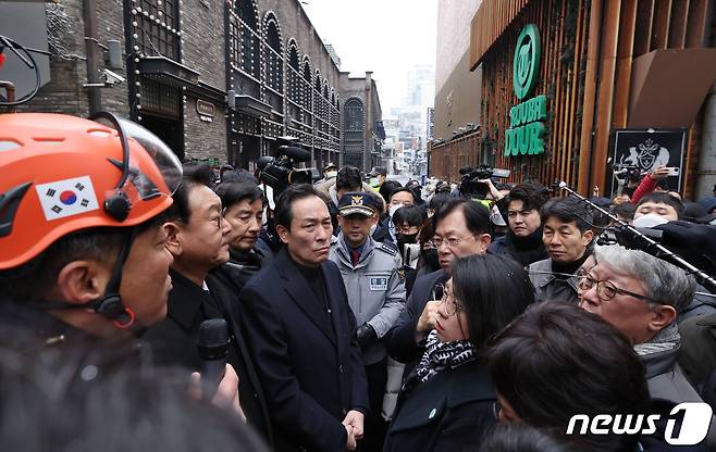 우상호 국회 용산 이태원 참사 진상규명과 재발방지를 위한 국정조사특별위원회 위원장이 21일 오전 서울 용산구 이태원 참사현장에서 최성범 용산소방서장의 브리핑을 듣고 있다. 2022.12.21/뉴스1 ⓒ News1 국회사진취재단