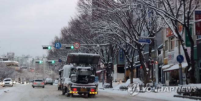 전주 폭설…눈길 서행하는 차량 (전주=연합뉴스) 김동철 기자 = 23일 대설특보가 내려진 전북 전주시 덕진구 모래내시장 일대에서 차량이 서행하고 있다. 2022.12.23 sollenso@yna.co.kr