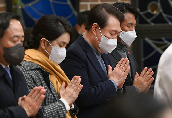 윤석열 대통령과 김건희 여사가 24일 서울 중구 약현성당에서 열린 ‘주님 성탄 대축일 미사’에 참석해 기도하고 있다. /대통령실 제공