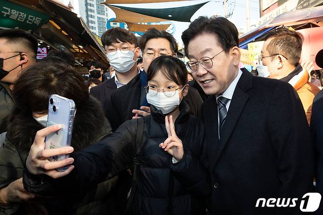 이재명 더불어민주당 대표가 11일 '국민 속으로, 경청투어' 민생 현장 방문으로 인천 남동구 모래내시장을 찾아 한 어린이와 기념 촬영을 하고 있다. 2023.1.11/뉴스1 ⓒ News1 유승관 기자